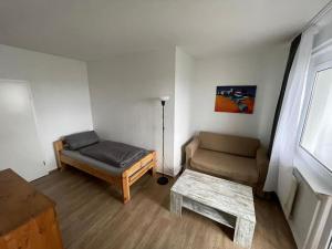 a living room with a couch and a table at Max Appartements in Neubrandenburg