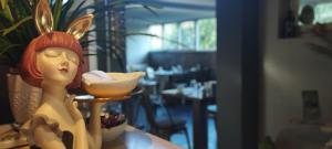 a figurine of a woman sitting on a table with a bowl of food at Hotel Sereno in Sestri Levante