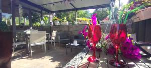 a patio with two red vases with flowers in them at Hotel Sereno in Sestri Levante