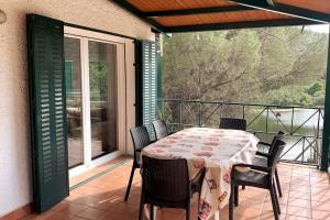a table and chairs on a balcony with a table and a view at La Casa del Lago in Navas del Rey
