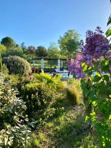 a garden with purple flowers and other plants at Le Mas du Fort in Gargas
