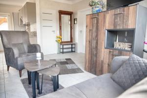 a living room with a couch and a fireplace at Runddorf 1 in Mönkebude