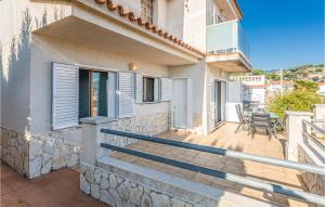 a balcony of a house with a table and chairs at Gorgeous Home In Sant Cebrià De Vallalt in Sant Cebrià de Vallalta +23 photos