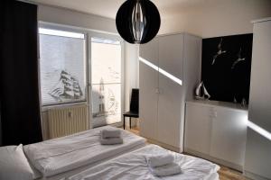 a bedroom with a white bed and a window at Lagunenstadt am Haff Fewo 119 - Marina in Ueckermünde