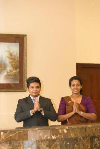 a man and a woman are doing a gesture at Devon Hotel in Kandy +119 photos