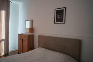 a bedroom with a bed and a mirror on the wall at Atlantis Atmosphere Apartment in Burgas City