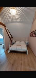 a bedroom with a bed in a room with a ceiling at Maison Boutaut 6 pers in Les Boulmiers