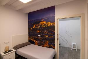 a bedroom with a poster of a city at Loft atenas in León