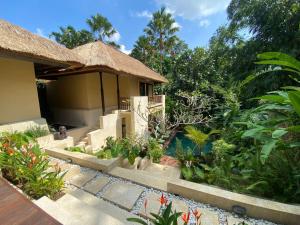 a garden in front of a house at Villa Purnamasari in Ubud