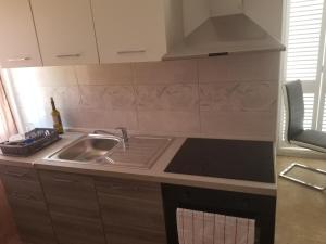 a kitchen with a sink and a stove at Villa Marko 3 Bedrooms apartment in Pula +12 photos