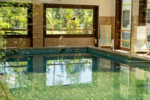 a swimming pool in the middle of a house at Pension Fischinger in Feldkirchen in Kärnten