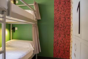 a bedroom with two bunk beds and a green wall at Room Valencia in Valencia