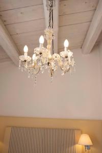 a chandelier hanging from a ceiling in a room at Hotel Palazzo Cavalieri in Syracuse