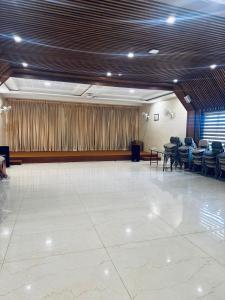 a large room with a stage with chairs and tables at Fortune Hills in Palakkad