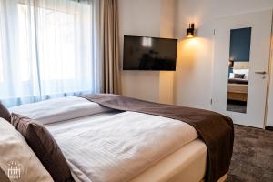 Postel nebo postele na pokoji v ubytování Hotel am Borsigturm