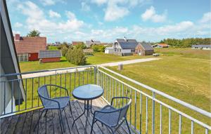 a balcony with chairs and a table and a field at Holiday Home Fiskervej Thisted Iii in Nørre Vorupør