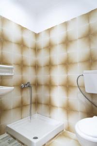 a bathroom with a sink and a toilet at ELPIS appartment in Vitalades