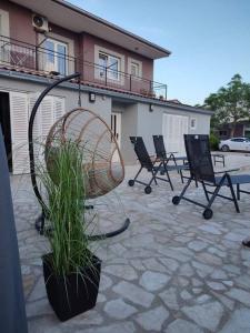 a patio with chairs and a fan and a plant at Villa Marko 3 Bedrooms apartment in Pula