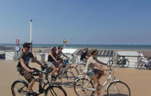 a group of people riding bikes on the beach at Residentie Zon & Zee Ref 20 in Ostend +7 photos