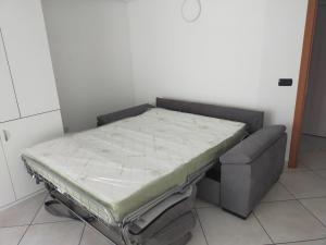 a bed in a room next to a couch at Amici in Castellammare di Stabia