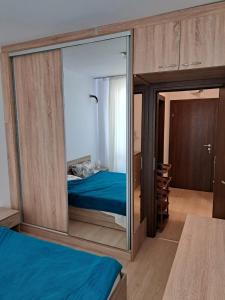 a bedroom with a mirror with a bed in it at Domus Extra Apartments in Sveti Vlas
