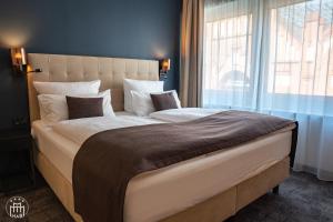 Postel nebo postele na pokoji v ubytování Hotel am Borsigturm