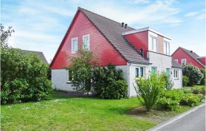 a red and white house with a red roof at Oesterbaai -5C1 in Wemeldinge +13 photos