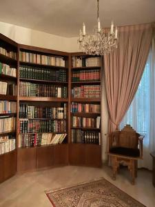 a library with large book shelves filled with books at Luxurious Ground Floor of a Villa in Elite Area in Amman