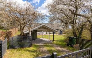 a house with a fence and a gate at Holiday Home Lyngsbækvej Ix in Ebeltoft +16 photos