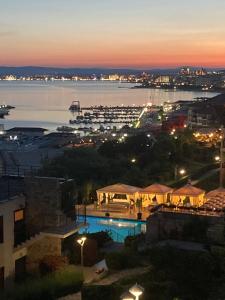 a view of the city and harbor at night at Dolce Vita Blue Boho, Premium Apartment with seaview in Sveti Vlas +70 photos