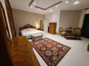 a bedroom with a bed and a rug on the floor at Luxurious Ground Floor of a Villa in Elite Area in Amman