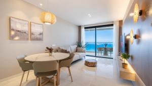 a living room with a table and a couch at Benidorm Beach, Grupo AMI in Benidorm