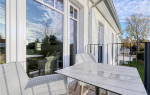 a patio with a table and chairs on a balcony at Baltischer Hof Apartment 31 in Boltenhagen