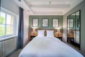 Postel nebo postele na pokoji v ubytování Hôtel Château Schengen