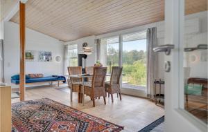 a living room with a table and chairs and a dining room at Holiday Home Ebeltoft 18 in Ebeltoft