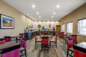 a restaurant with tables and chairs and a counter at Comfort Inn & Suites Macon in Macon