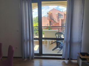 an open door to a balcony with a table at Domus Extra Apartments in Sveti Vlas