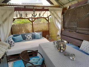 a room with a bed and two tables in a tent at Happy Home in Budikovany