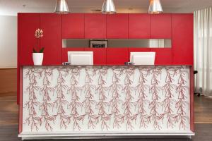 a red and white counter in a room with red cabinets at Thon Hotel Halden in Halden