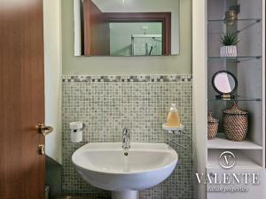 a bathroom with a sink and a mirror at Lamante apartment in Lucca in Lucca +17 photos
