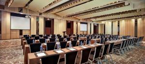 a large room with rows of tables and chairs at Banyan Tree Tianjin Riverside in Tianjin