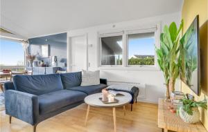 a living room with a blue couch and a table at Amazing Home In Vejby With Wifi in Vejby