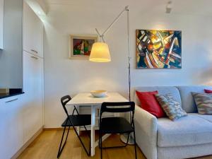 a living room with a table and a blue couch at Comfortable 1-Bedroom Apartment Near Monaco in Roquebrune-Cap-Martin