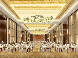a large banquet hall with white tables and chairs at Eurasia Convention International Hotel in Wuhan
