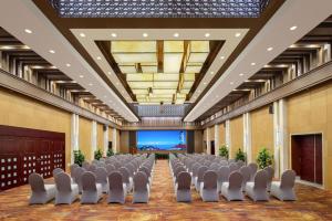 an empty conference room with chairs and a screen at Nanshan Leisure Villas in Shangsimacun +265 photos