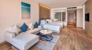 a living room with a couch and a table at Homstay A LA CARTE HẠ LONG 1PN in Ha Long