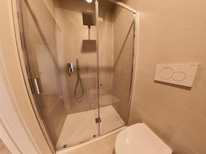 a shower stall in a bathroom with a toilet at Hotel Tritone in Trieste