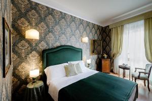 Postel nebo postele na pokoji v ubytování Hotel Palazzo dal Borgo