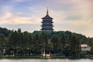 a pagoda in the middle of a lake with a building at Jinjiang Inn Hangzhou Xihu Avenue Branch in Hangzhou