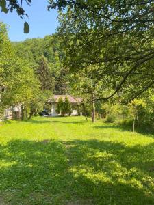 a house in the middle of a field with trees at Vila Dina in Sarajevo +14 photos